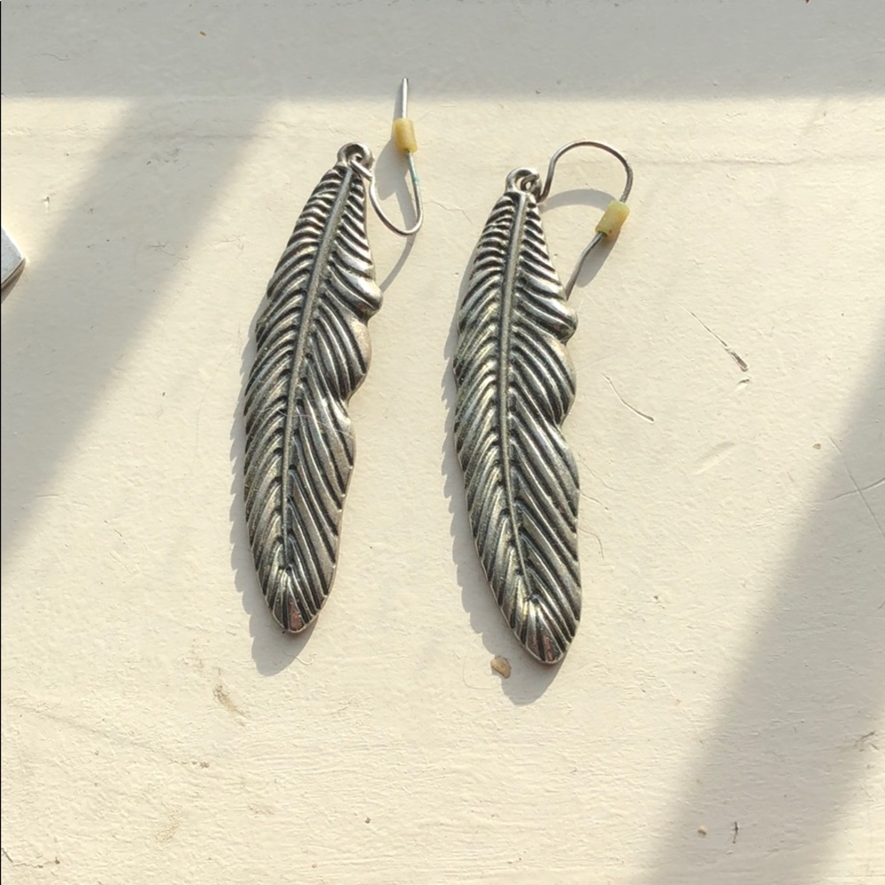 Silver colored feather earrings